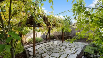 Easy-care and low-maintenance, this gorgeous backyard is ready for relaxing, gardening, or simply soaking up the peaceful surroundings.