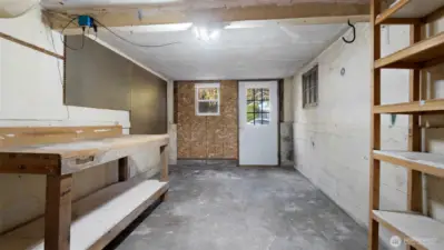 What a fantastic workshop! Complete with a sturdy built-in bench, plenty of shelving, and a pegboard ready for your tools and projects, this space is a dream setup for anyone who loves to tinker, build, or create.