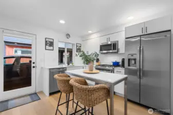 Modern kitchen with ample cabinetry, pantry, & generous prep space.