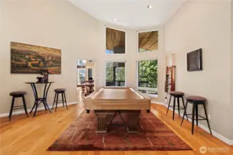 This versatile space can be a separate living room or used as it is currently.  With well-maintained hardwood floors throughout and floor to ceiling windows, it can be styled to be elegant or cozy, flowing seamlessly into the landscape outside.