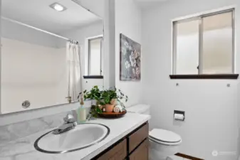 The shared bathroom is conveniently located in the hall,steps from the bedrooms. Don't miss seeing the huge sunken tub/shower!
