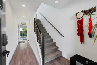 Entry with wide staircase and wide hall towards 4th, large bedroom.