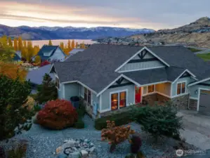 Aerial view of home w/ uplake Lake Chelan views and large, landscaped lot.