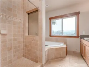 View of the main level Primary Bedroom Bathroom Suite w/ double vanities, granite countertops, European tiles and a spa-like Jacuzzi tub.