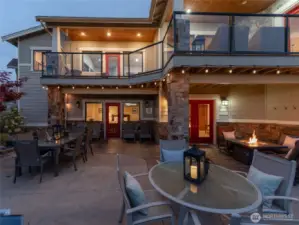 Aerial twilight view 2 of the 5bd/4th 3,441sf home w/ upper level Lake Chelan view decks and lower level outdoor living area w/ dining, lounge and BBQ area.