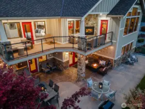 Aerial twilight view 3 of the 5bd/4th 3,441sf home w/ upper level Lake Chelan view decks and lower level outdoor living area w/ dining, lounge and BBQ area.