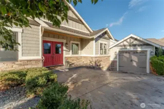 Exterior view of front door and driveway w/ 3-car attached garage.