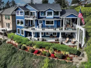 Drone from Southside of home.  Landscaped for low maintenance. Wonderful three stories of a masterpiece.