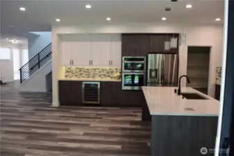 Another view of the Gorgeous Dry Bar with Wine Fridge. Large Dining Island with Beautiful Slab Quartz Countertops.