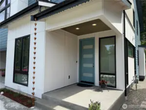 Welcoming Covered Entry with Beautiful Wood Ceiling with Recessed Lighting. Notice the Beautiful Stylish Front Door with Glass Panels.