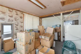 Addition that has the kitchen on the far wall.  Currently storing moving boxes to prepare for the move.