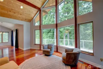 Living area with floor to ceiling windows.