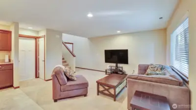 The living room is open and filled with natural light.