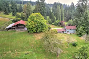 View of back of the original home and the Large stalled barn