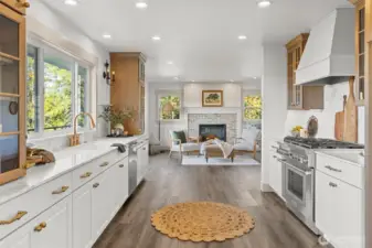 Chef's kitchen with high-end Thermador appliance package, including 6-burner gas stove, custom vent hood, marble countertops and backsplash and undercabinet lighting, on dimmers.