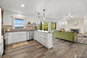 Lower-level family room with custom brick and shiplap fireplace, full kitchen with LG stainless steel appliance package and secondary utility room! Access to covered patio with recessed lighting and board and batten ceiling detail. Perfect for enjoying the view year-round!