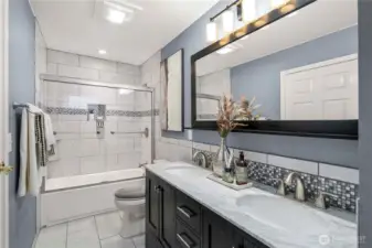 Fully tile surround and updated vanity, lights and flooring.