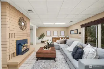 Wood burning stove, large fireplace surround and a wet bar make this huge space cozy and great for entertaining or movie nights at home.