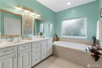 Primary bath with large tub and double shower.