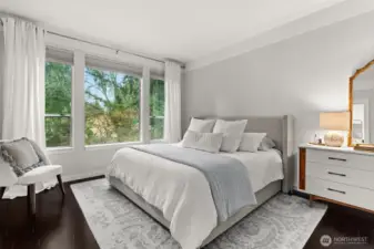 Primary Bedroom with oversized windows overlooking private backyard