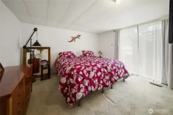 Primary bedroom with slider leading out to a private deck.