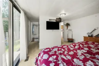 Another view of the primary bedroom showing the attached full bathroom.