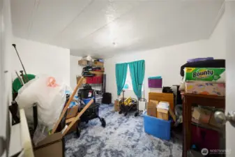 Third bedroom shown with belongings.