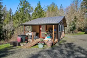 Shed/shop shown with belongings.
