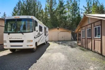 A view showing your large parking area, two car garage with carport and large shed.