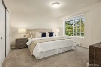 Primary bedroom with ample natural light, space, and storage.