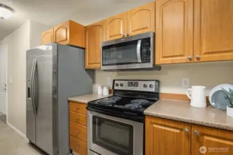 Kitchen with stainless steel stove and microwave.