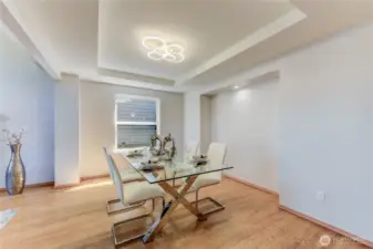 The formal dining area seamlessly opens to the living room, creating an airy, connected space ideal for both intimate dinners and larger gatherings.