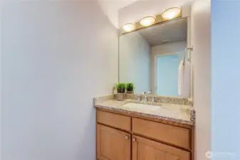 A powder room is conveniently located on the main level, perfect for guests and everyday use