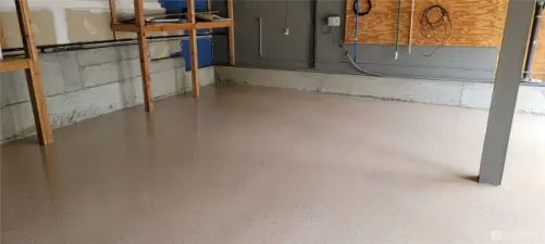 Spacious garage featuring a sleek epoxy-coated floor for durability and easy maintenance