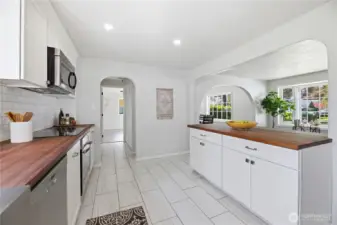 Updated kitchen with coved passthroughs adding so much charm to this bright and open space
