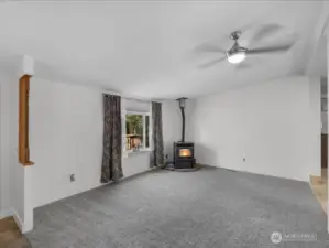 Living room with Lopi pellet stove and new carpet.