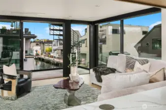 Living room with spiral staircase to expansive rooftop deck