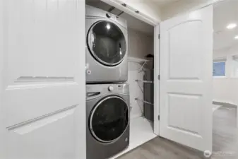 Laundry closet with additional storage.