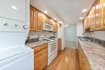 Second view of large updated kitchen with its own stack washer/dryer that stay with unit