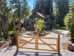 Freshly poured driveway, new gate & architectural landsacping