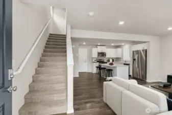 Entry foyer reveals open concept layout and easy stair access to private bedrooms and loft upstairs. Pictures are for representational purposes only, colors and features may vary.