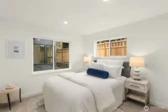 Secondary bedroom filled with natural light, offering flexibility for guests, children, or creative workspace. Photos are of model home with similar fixtures & finishes.
