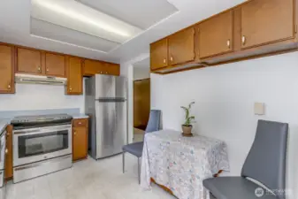 The kitchen looks out over the back yard and opens to the dining area.