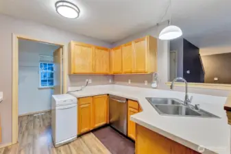 Laundry room with shelving off the kitchen.