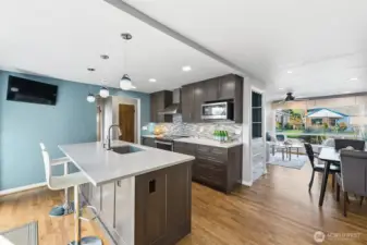 The kitchen is gorgeous. Remodeled in 2021 it features new cabinets, lighting, quartz counters, tile back splash and appliances.