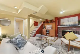 Lower level offers a cozy family room with second wood burning fireplace, built in for TV and storage and plenty of space for relaxation.