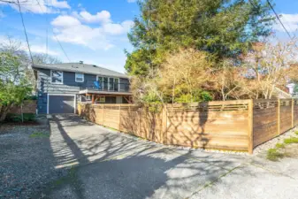 Long driveway off the paved alley provides parking for several vehicles. The garage is a 2 car tandem or one plus plenty of space for a shop or storage.
