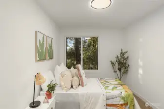 Bright and tranquil, this guest bedroom boasts serene views and thoughtful details to make everyone feel right at home—the perfect retreat for relaxation.