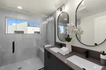Step into luxury in the spa-inspired primary bathroom, where sleek double vanities and a glass-enclosed rain shower create a serene retreat.