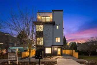 Framed against a dreamy sunset sky, the front view of this home invites you to step into a space where comfort meets cutting-edge design. Your next chapter begins here.